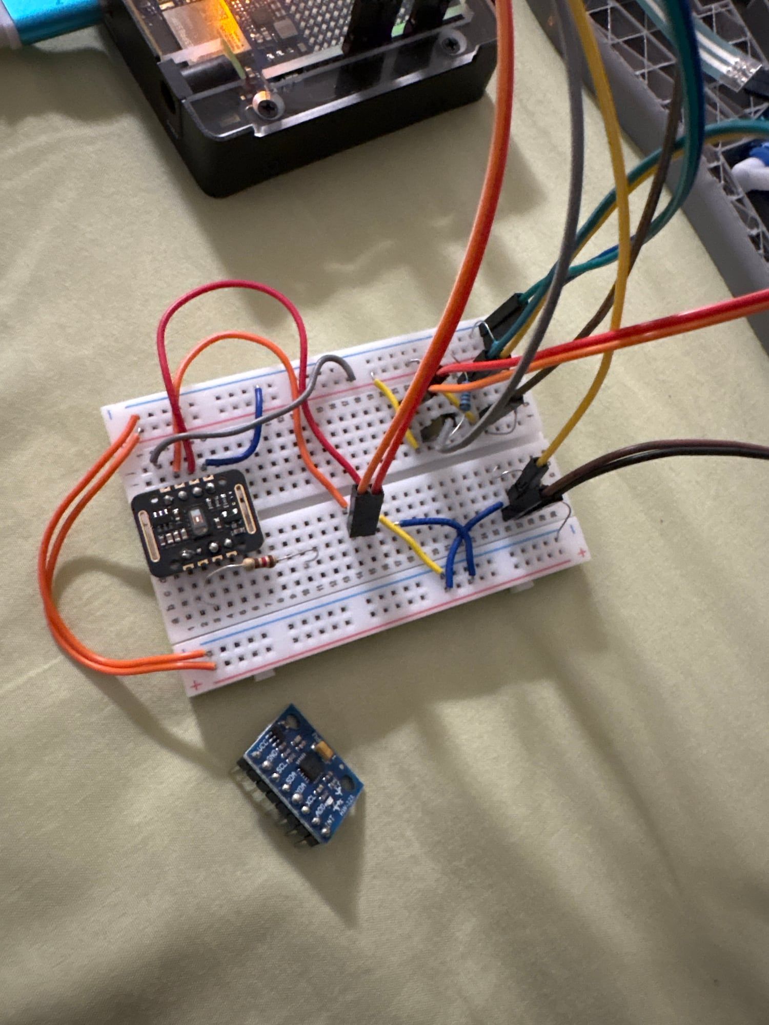 The breadboard circuit with the heart-rate sensor module, next to the MPU-6050 motion sensor board.